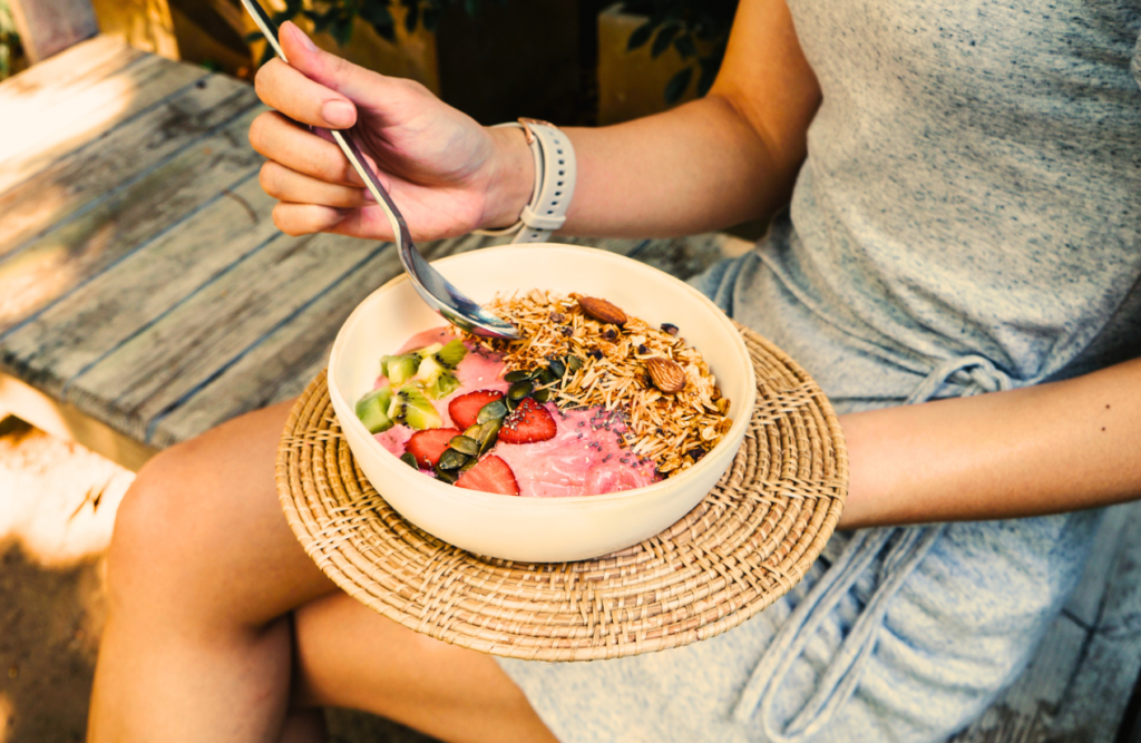 Woman eating smoothie bowl for breakfast. Kick Start Weight Loss. Brisbane Livewell Clinic