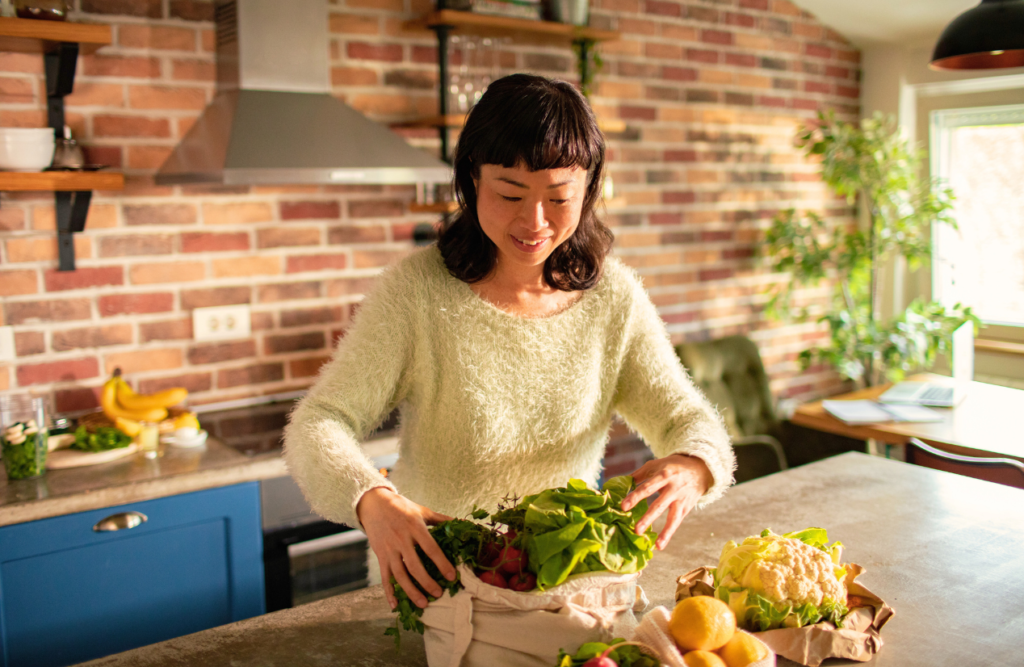 Woman getting the groceries out of the bag. Nutrition and Naturopathy. Acne Naturopath. Brisbane Livewell Clinic