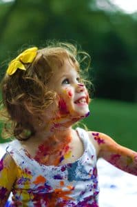 Smiling girl with paint on her face. Kinesiology for Kids. Kinesiology for Children