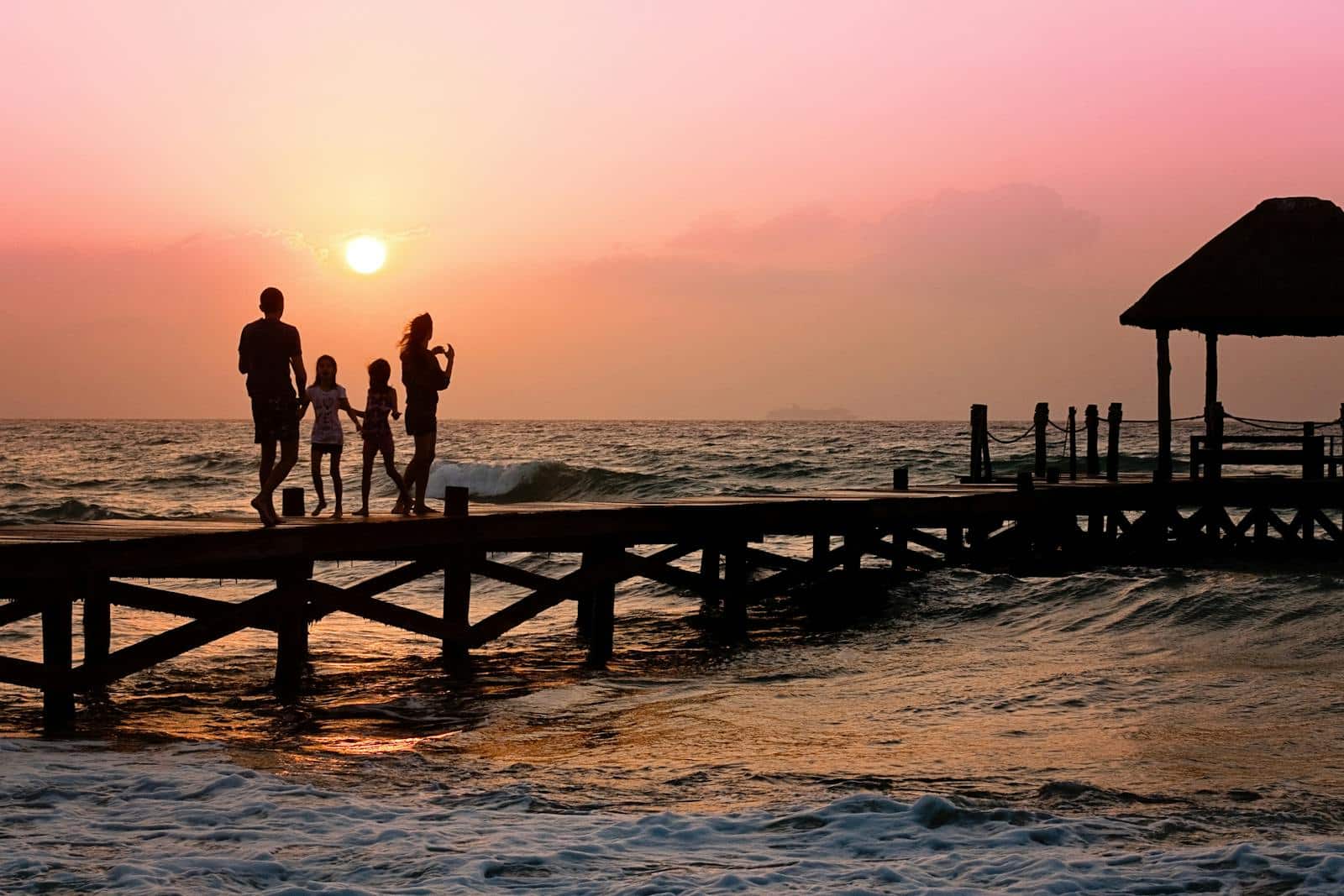 Family Standing on Dock during Sunrise. Acupuncture for Fertility. Brisbane Livewell Clinic.