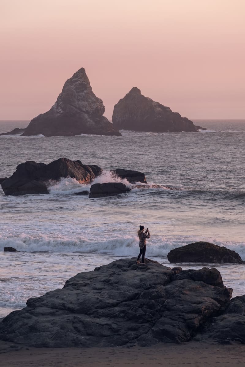 Hypnotherapy. Brisbane Livewell Clinic. A man standing on top of a rock near the ocean