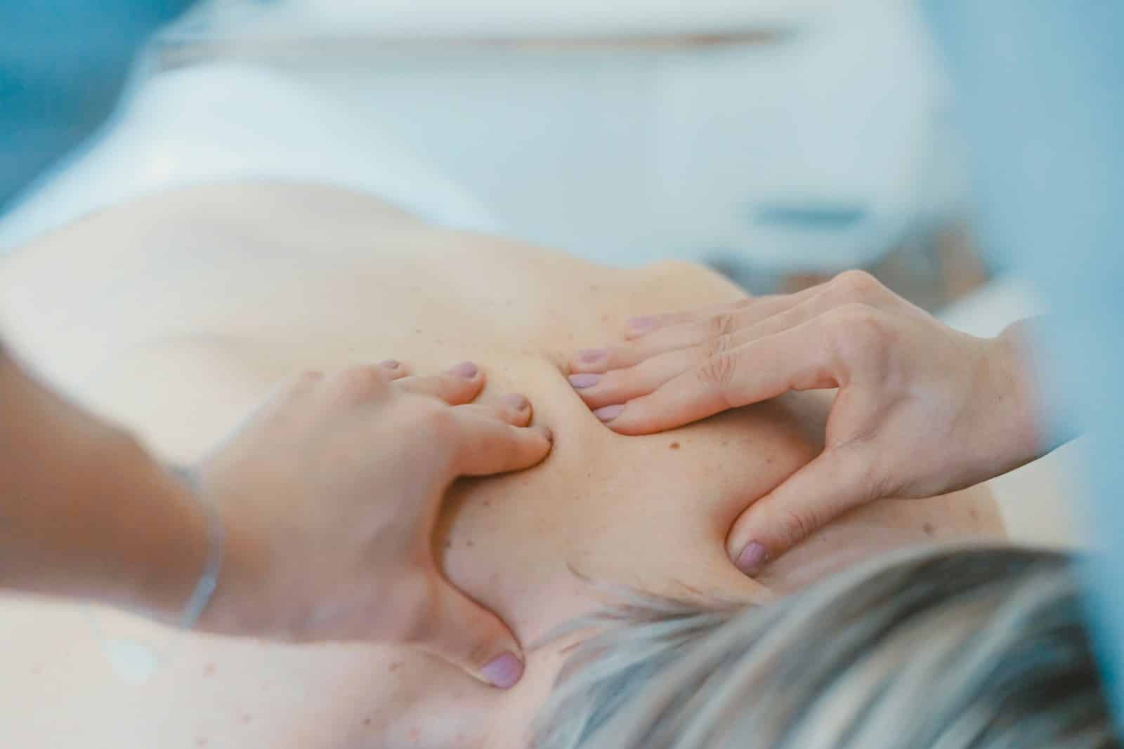 Masseuse massaging the back of a woman. Remedial Massage