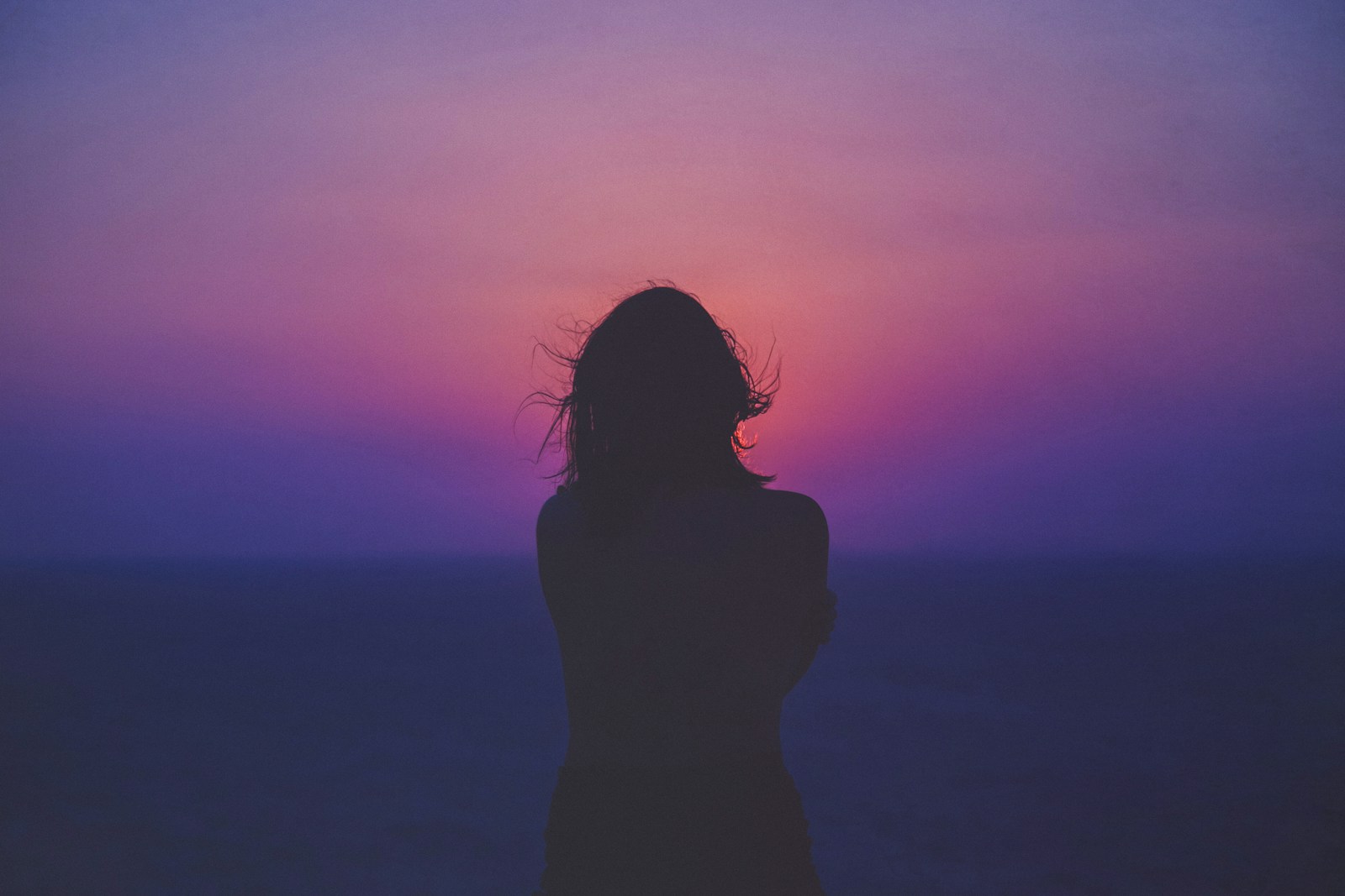 silhouette of a woman with pink and purple sky. Psychosomatic Therapy Brisbane