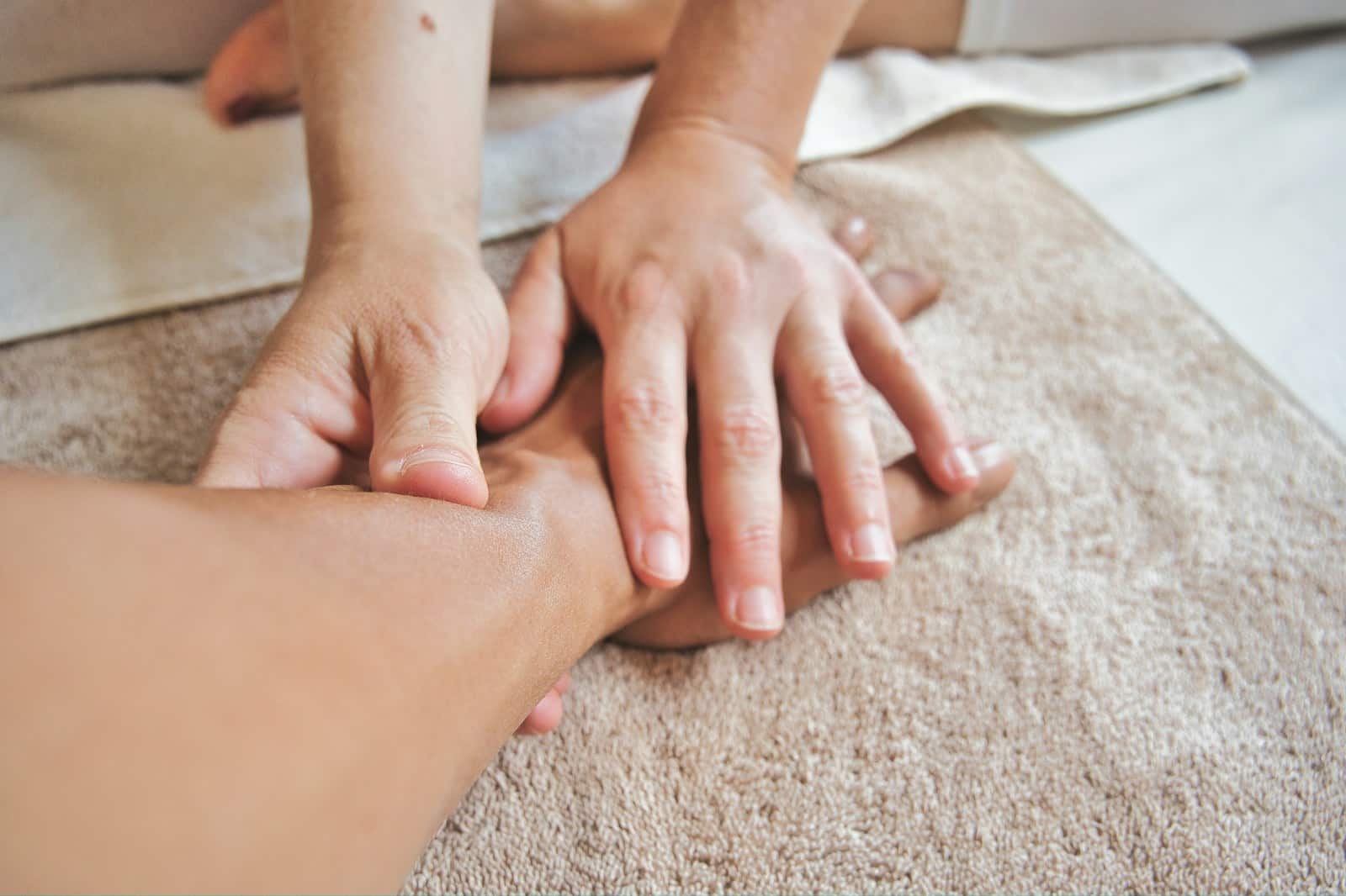 Person getting remedial massage on their arm by a massage therapist