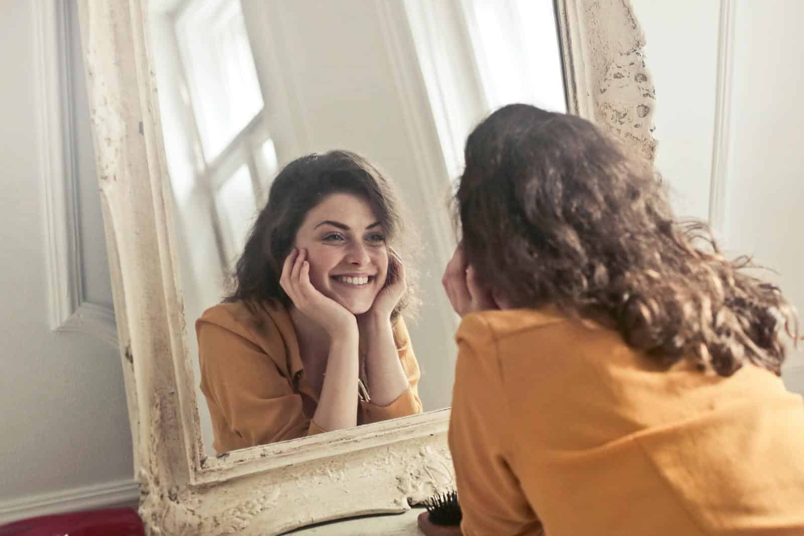 Photo of Woman Looking at the Mirror, happy with her thyroid treatment