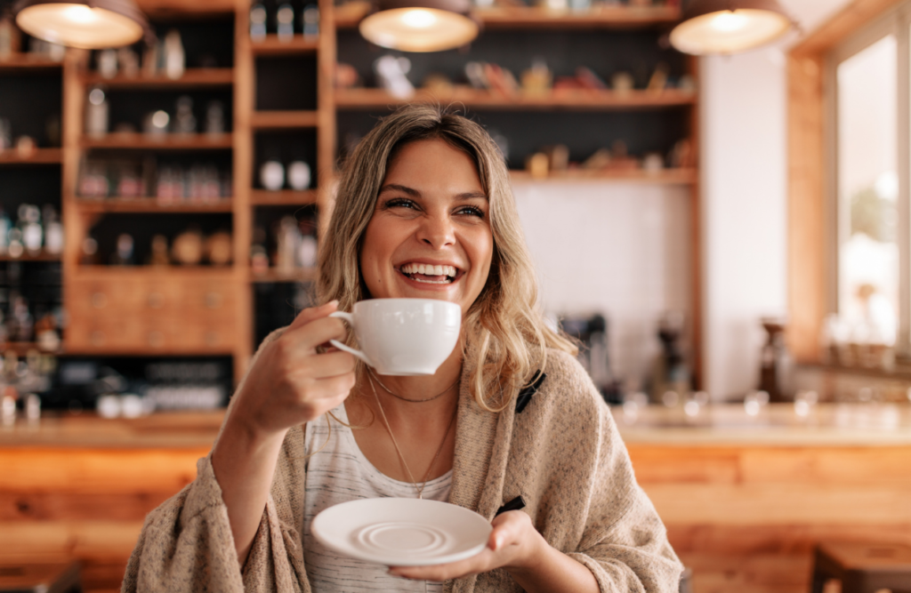 Woman drinking a cup of coffee in a cafe. Is hypnotherapy covered by Medicare. Counselling Near Me. Brisbane Livewell Clinic. Hypnotherapy Quiz. Hypnosis Quiz