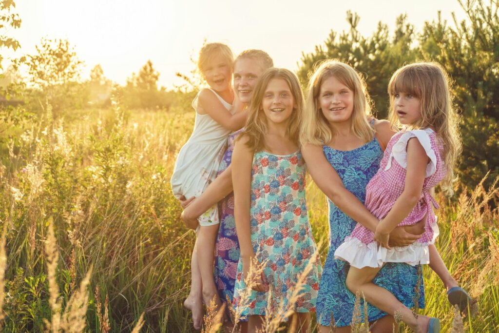 Happy family standing in long grass. Brisbane Wellness Centre