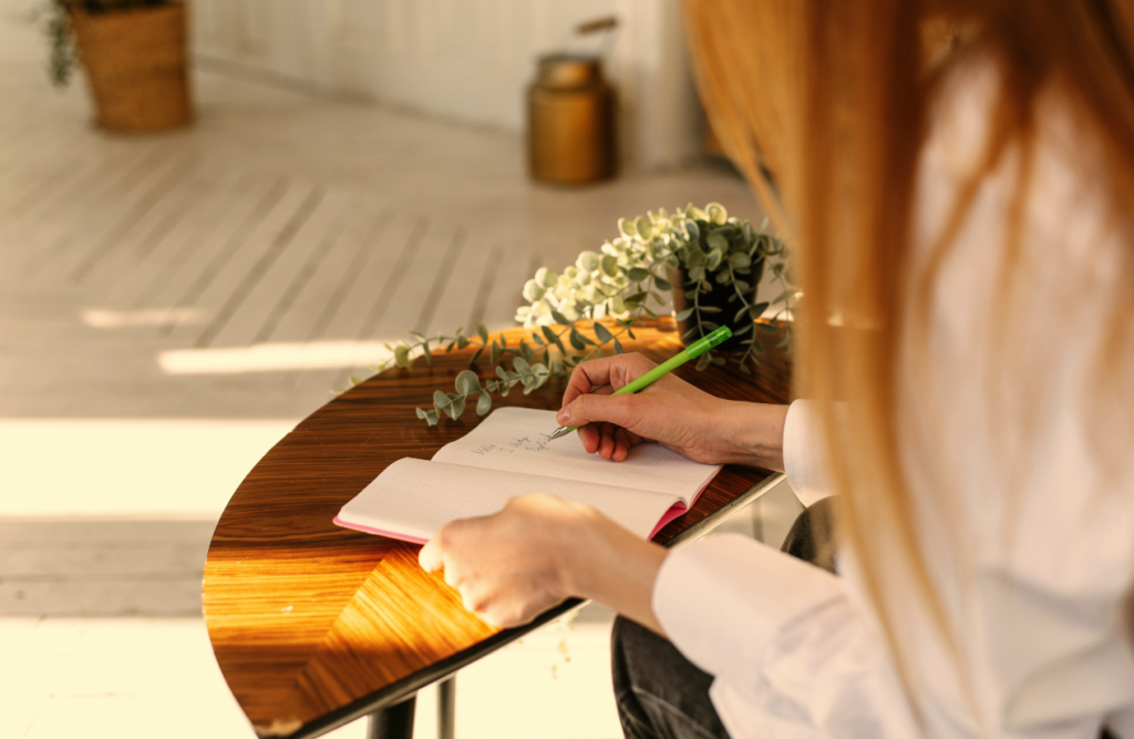 Woman writing on a paper. Naturopath Sunshine Coast. Brisbane Livewell Clinic