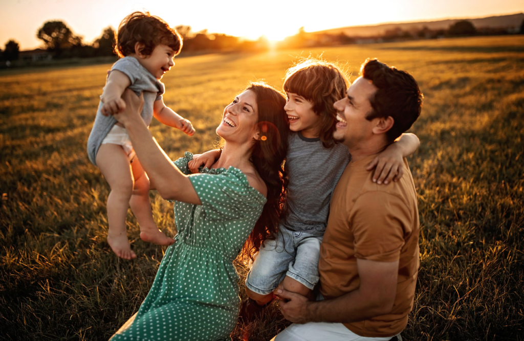 Parents playing with their kid at a field. Naturopath Sunshing Coast. Brisbane Livewell Clinic