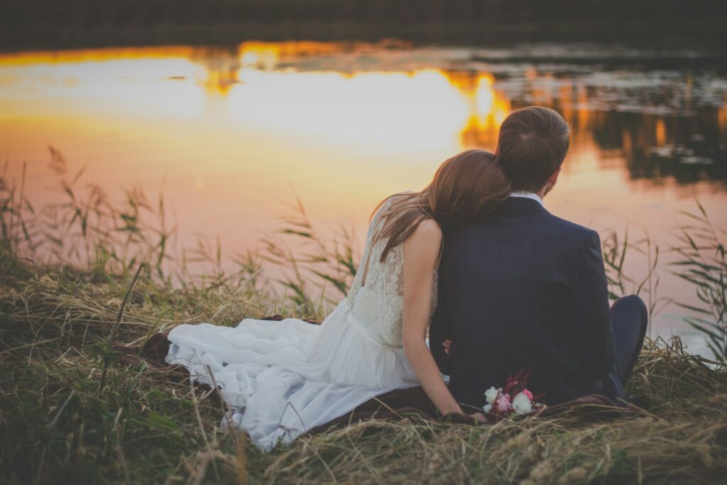 Man and woman cuddling beside a lake. Bowen Therapy Brisbane