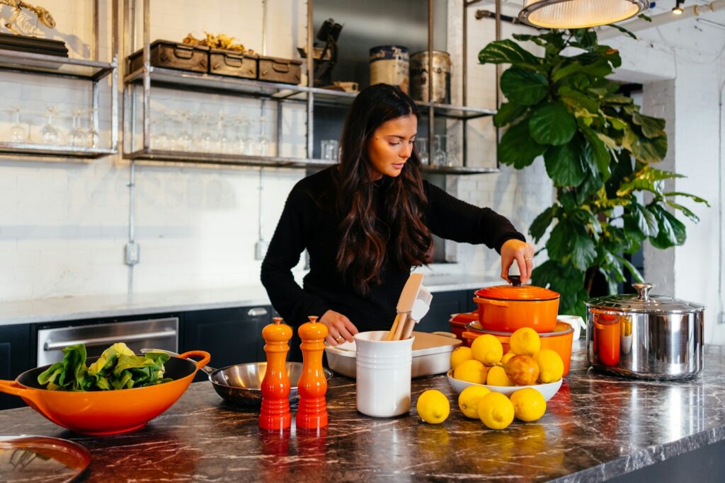 Woman cooking healthy foods in her kitchen. Best Wellness Centre Brisbane