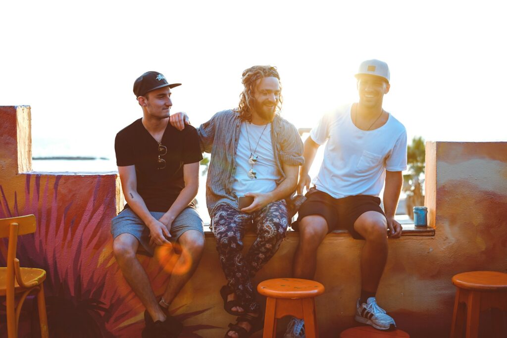 Three men sitting on stools. Brisbane Wellness Centre.