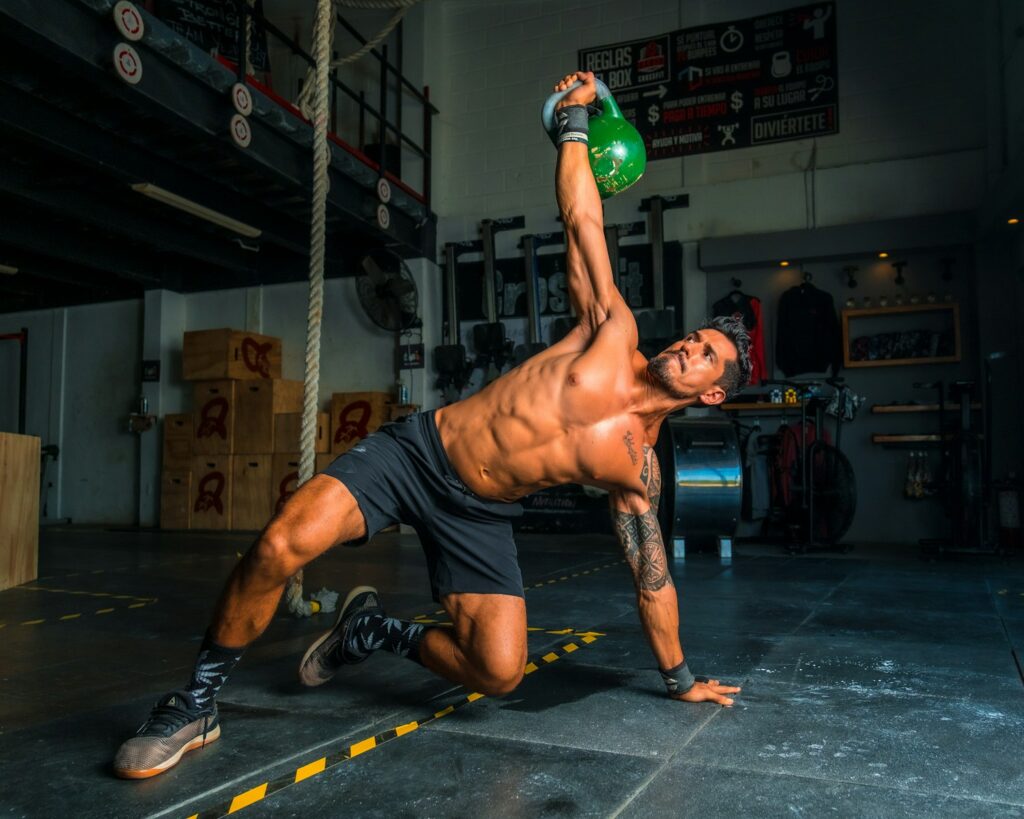 Man in black shorts and black tank top doing push ups. Heavy Metal Detox for Athletes