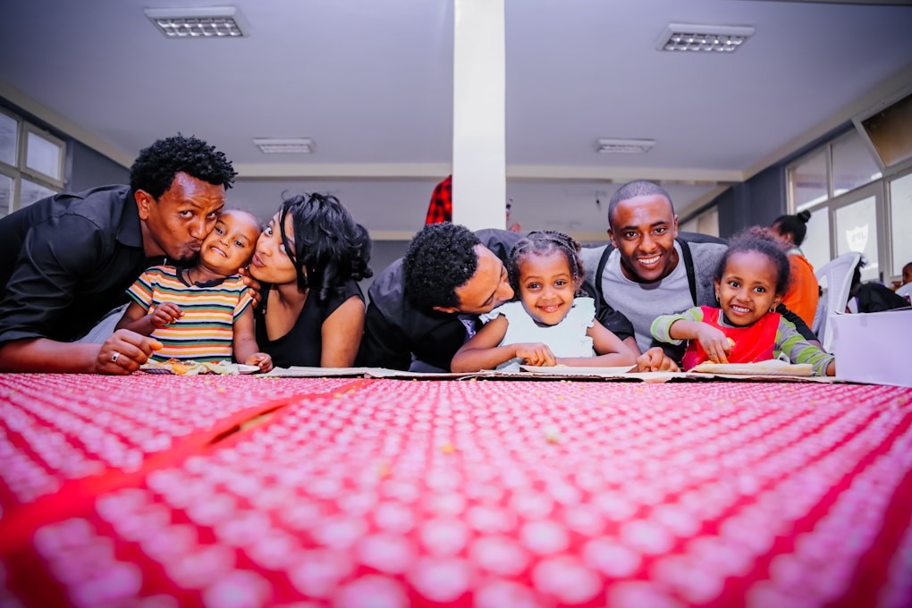 Family sitting at the table, smiling. Weight Loss Hypnosis Brisbane