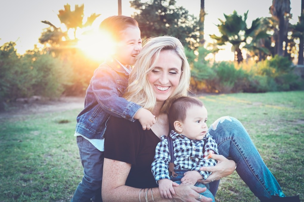 Woman with her children sitting in a park. Hypnosis Brisbane. How can Naturopath help