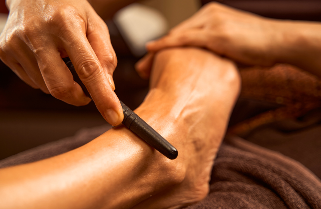 Practitioner using reflexology stick during Thai foot Massage Northgate. Reflexology. Brisbane Livewell Clinic