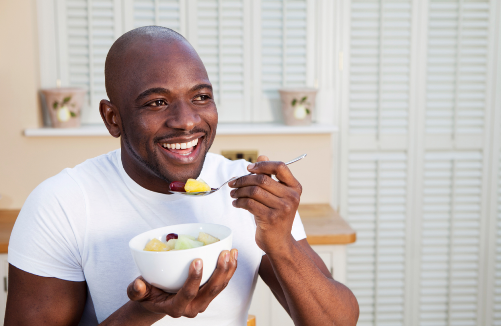 Man eating bowl of healthy food after Nutrient Testing for Methylation at Brisbane Livewell Clinic