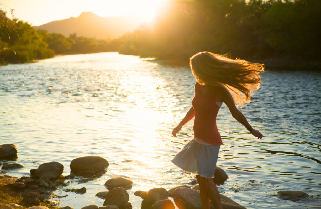 Woman having fun in the lake. Gut Health Brisbane. Brisbane Livewell Clinic. Why should I see a Naturopath?