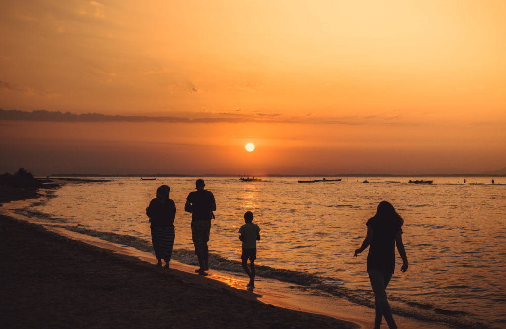 Silhouette of family walking on seashore during sunset. Swedish Massage Brisbane. Brisbane Livewell Clinic