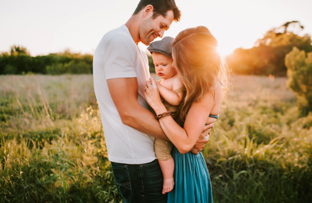 Photo of a family in a field during sunset. Thai Massage. Brisbane Livewell Clinic. Counselling Clayfield