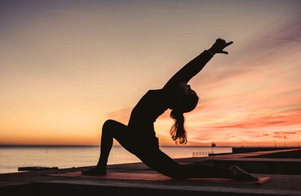 Silhouette of a woman doing yoga outdoors. Thai Massage. Brisbane Livewell Clinic