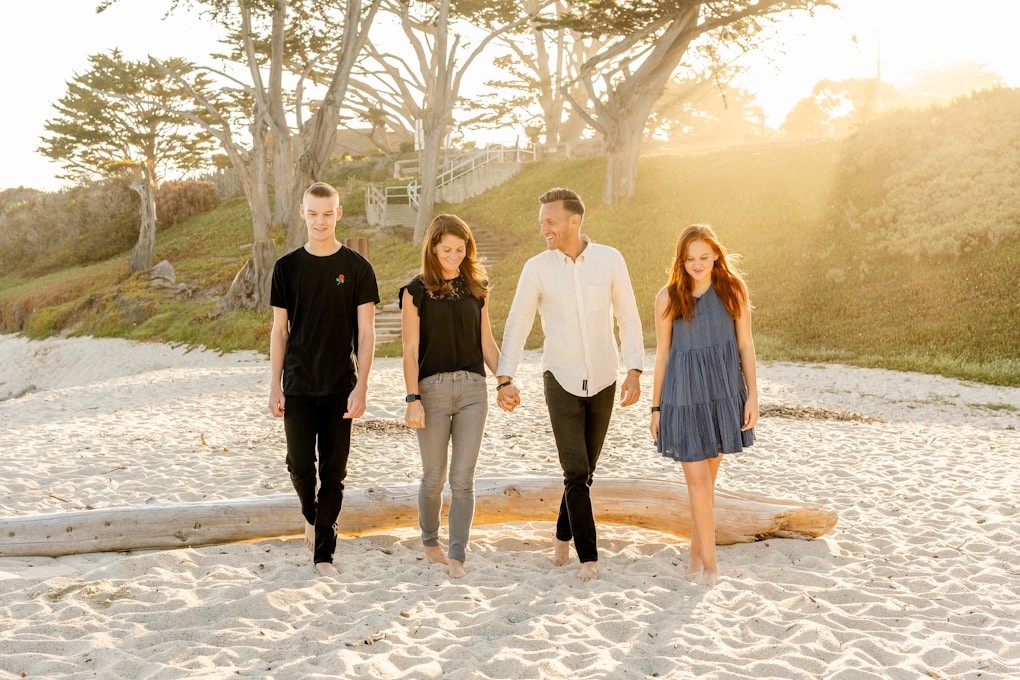 4 friends walking on the beach. Acupuncture Brisbane. Why see a Naturopath