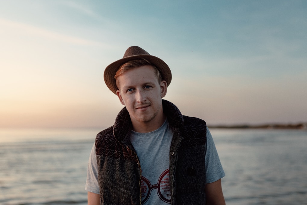 Man in brown hat and blue denim jacket standing on beach. What is Counselling?