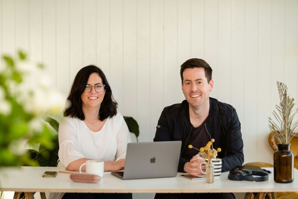 A Naturopath and patient sitting at a table with a laptop during a Naturopath consultation for Heavy Metal Detox