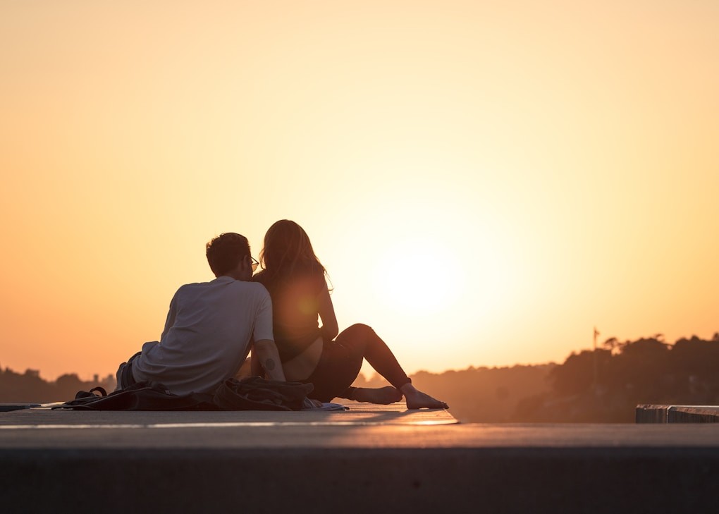 Couple sitting near trees during golden hour. Youth Counselling Brisbane