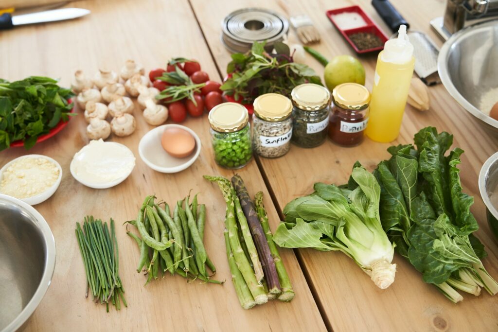 Green cruciferous vegetables and garlic plus other ingredients on brown wooden table. Dietary treatment protocols for Heavy Metal Detox