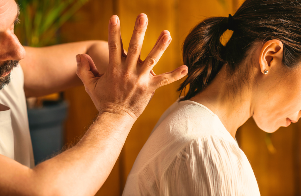 Woman with back pain receives traditional Massage Clayfield. Thai Massage. Brisbane Livewell