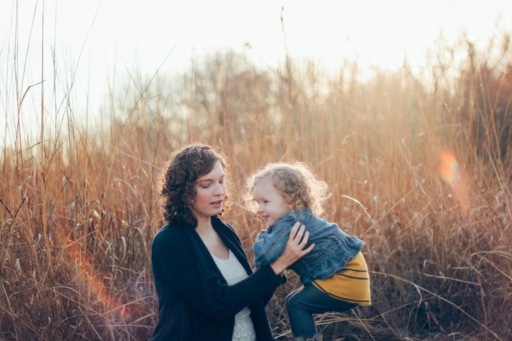 Mother carrying her child in grasses. Weight Loss Hypnosis Brisbane