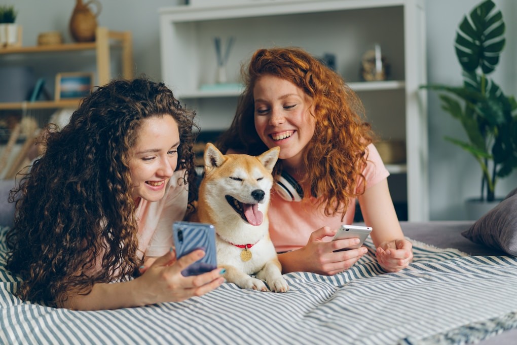 Two women laying on a bed with a dog. What Counselling? Naturopath Brisbane Northside.