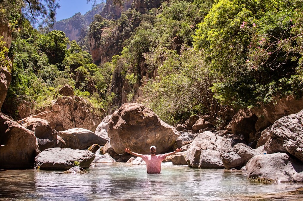 Person standing in a rock pool, after dealing with life's challenges with Hypnosis