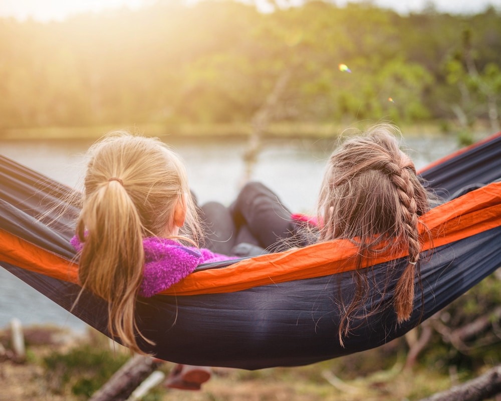 Two children lying on hammock. What does a Counsellor do?