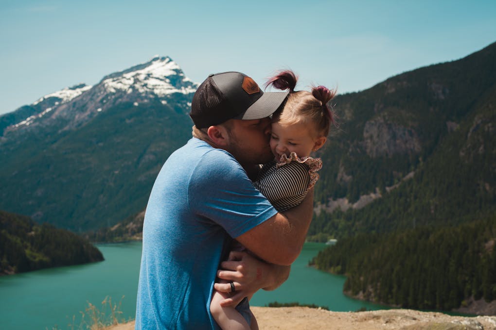 Father Hugging and Kissing his Daughter. Homeopathy vs Naturopathy. Homeopathic vs Naturopathic Medicine