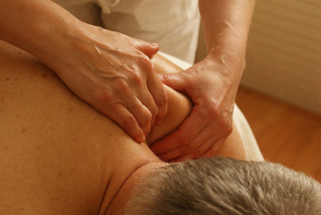 Therapist Massaging Man's Shoulder. Myofascial Release Therapy what is?