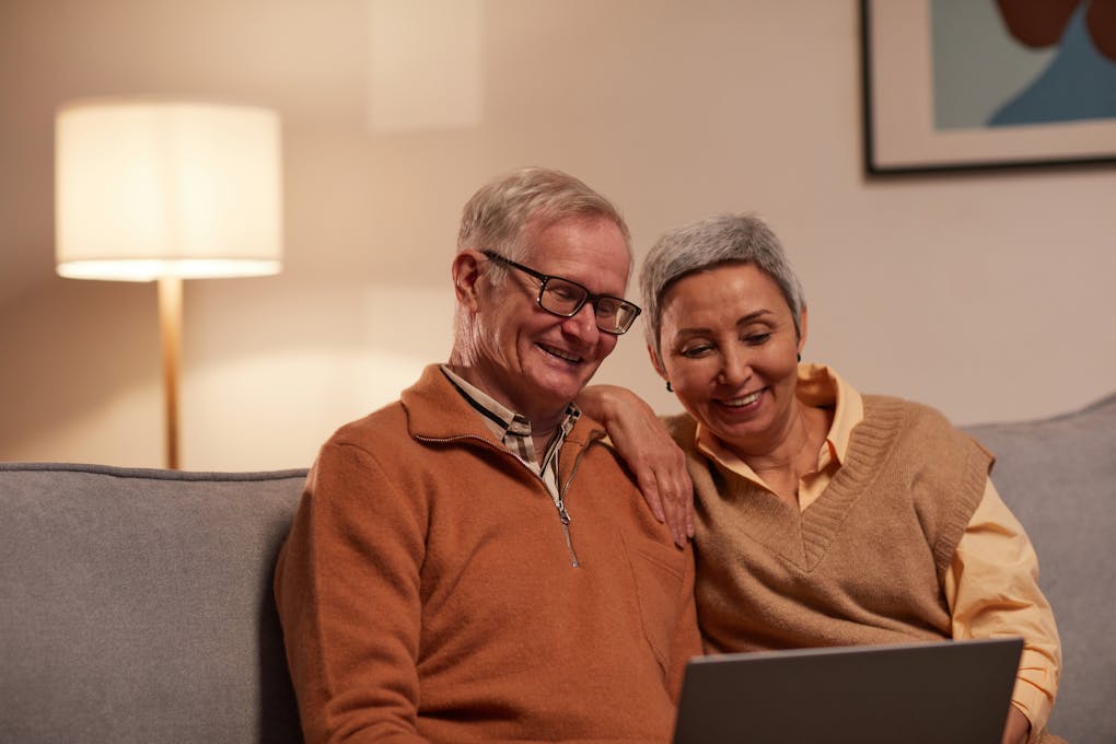 Man and Woman Sitting on Sofa While Looking at a Laptop. Clinical Hypnotherapy Cannon Hill