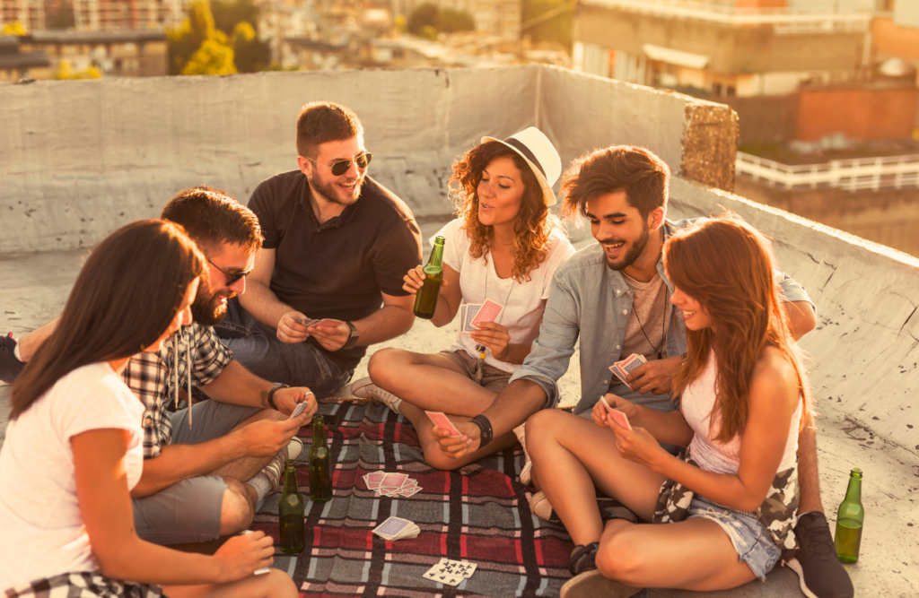 Friends playing cards on the rooftop. Hypnotherapy Facts. Brisbane Livewell Clinic. Naturopaths Brisbane Northside