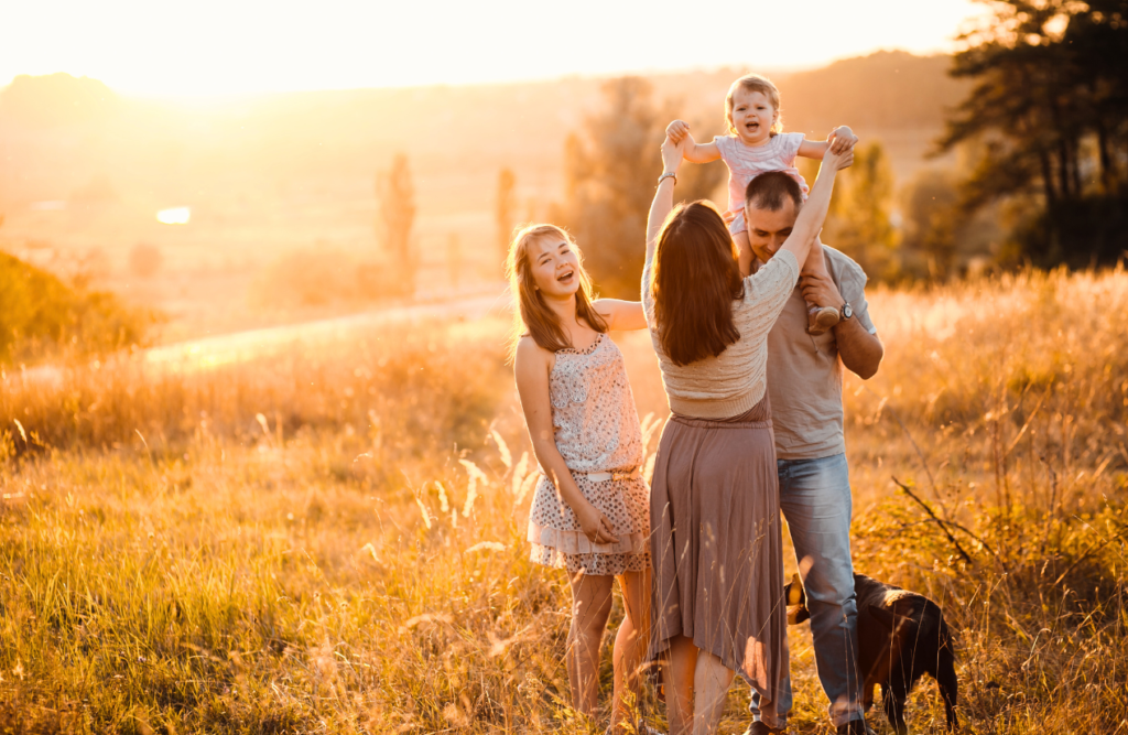 Family having fun together with their dog in a summer field. Iridology. Brisbane Livewell Clinic. Best Naturopath Near Me. Best Naturopaths Near Me. Naturopath Brisbane. Gut Health Specialist Brisbane