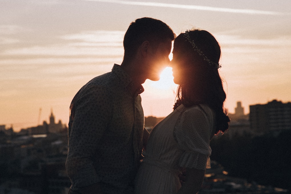 Man and a woman standing in front of a sunset. What is Lymphatic Drainage Massage?