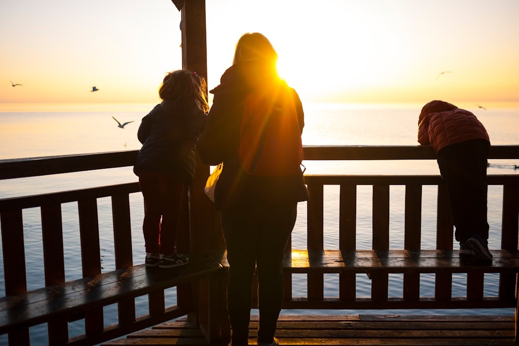 Family standing on a verandah at sunset. Counselling near me