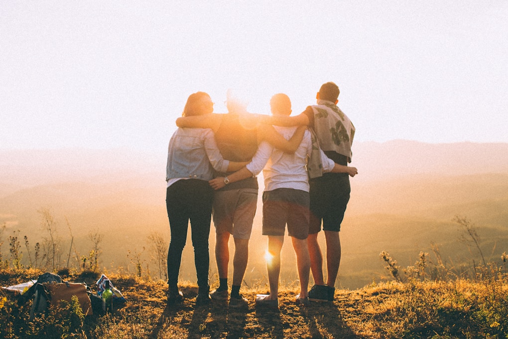 Four adults hugging at sunset. Clinical Hypnotherapy Cannon Hill