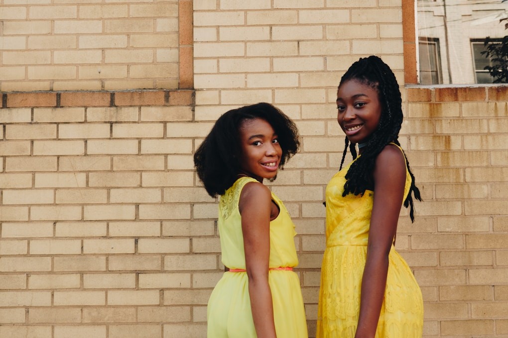 Two teenagers wearing yellow sleeveless dresses. Counselling Near Me at Wavell Heights in Brisbane