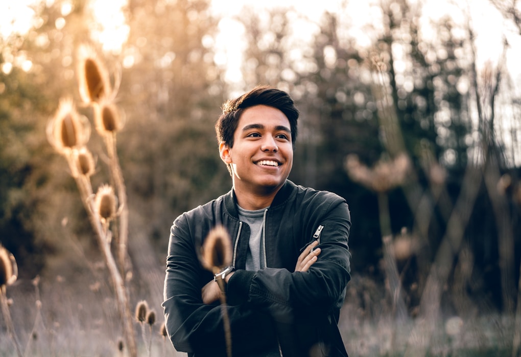 Smiling man standing in tall grasses. Clinical Hypnotherapy Cannon Hill