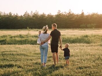 Family walking in a field. Indian Head Massage