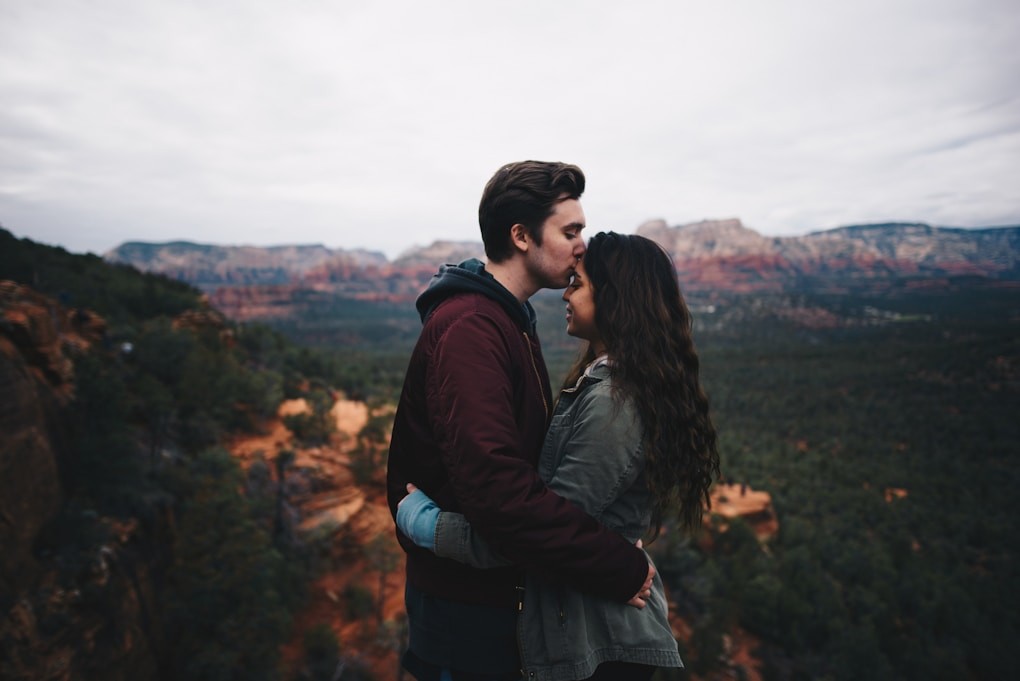 Man kissing woman's forehead after Indian Head Massage