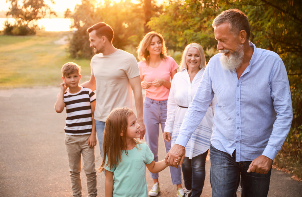 A happy family walking together outdoors at sunset. Naturopath North Brisbane. Brisbane Livewell Clinic. Hypnotherapy for Smoking. Hypnotherapy to Quit Smoking