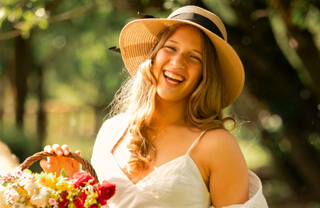 Happy woman holding a basket of flowers. Naturopath Cannon Hill. Brisbane Livewell Clinic