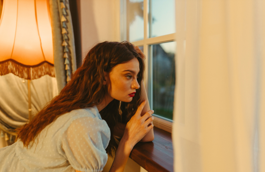 Young woman looking out the window. Naturopath Cannon Hill. Brisbane Livewell Clinic